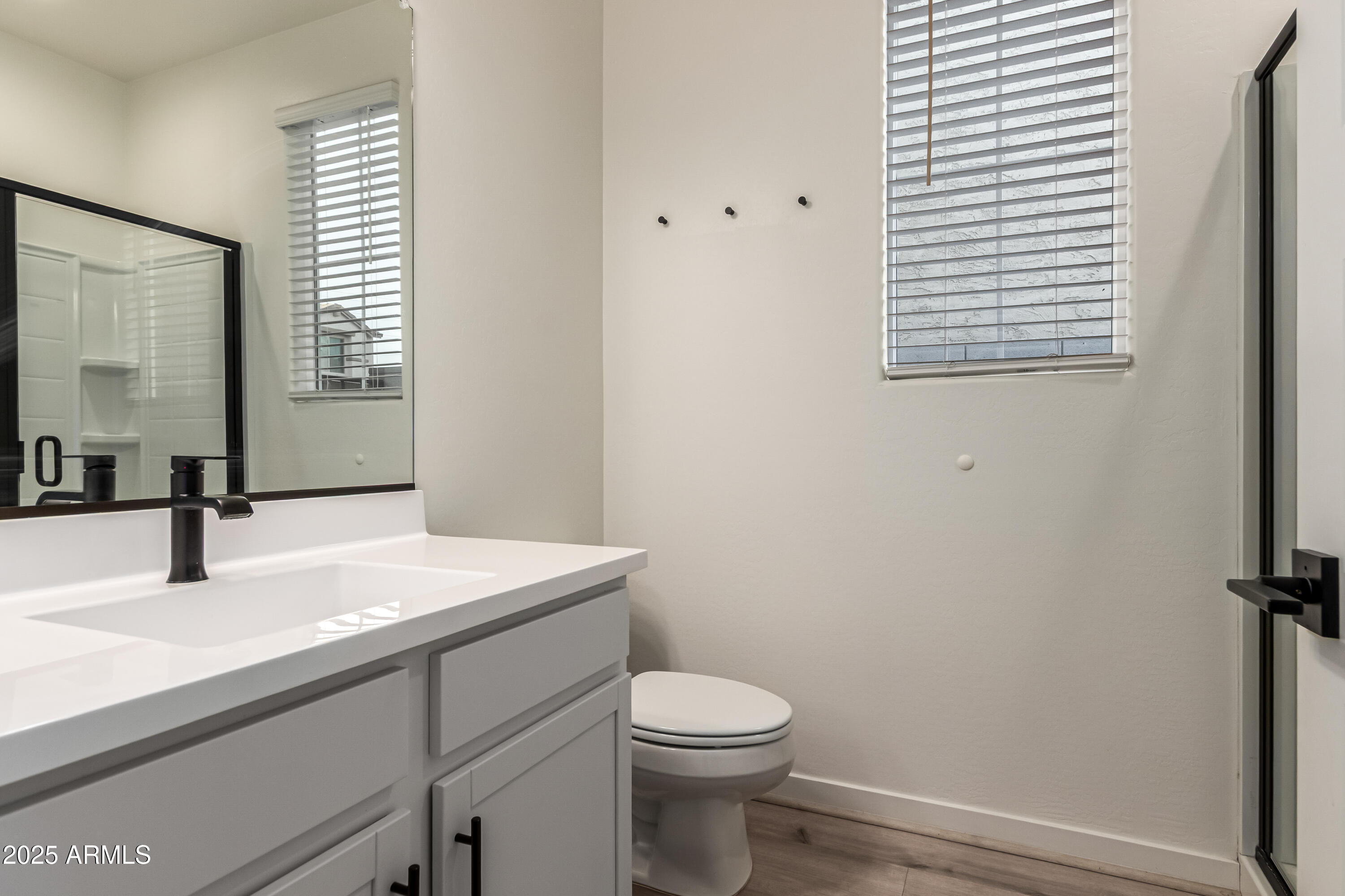 20 East Main Street Mesa, AZ 85201 - Photo 23 of 46 a bathroom with a sink a toilet and mirror