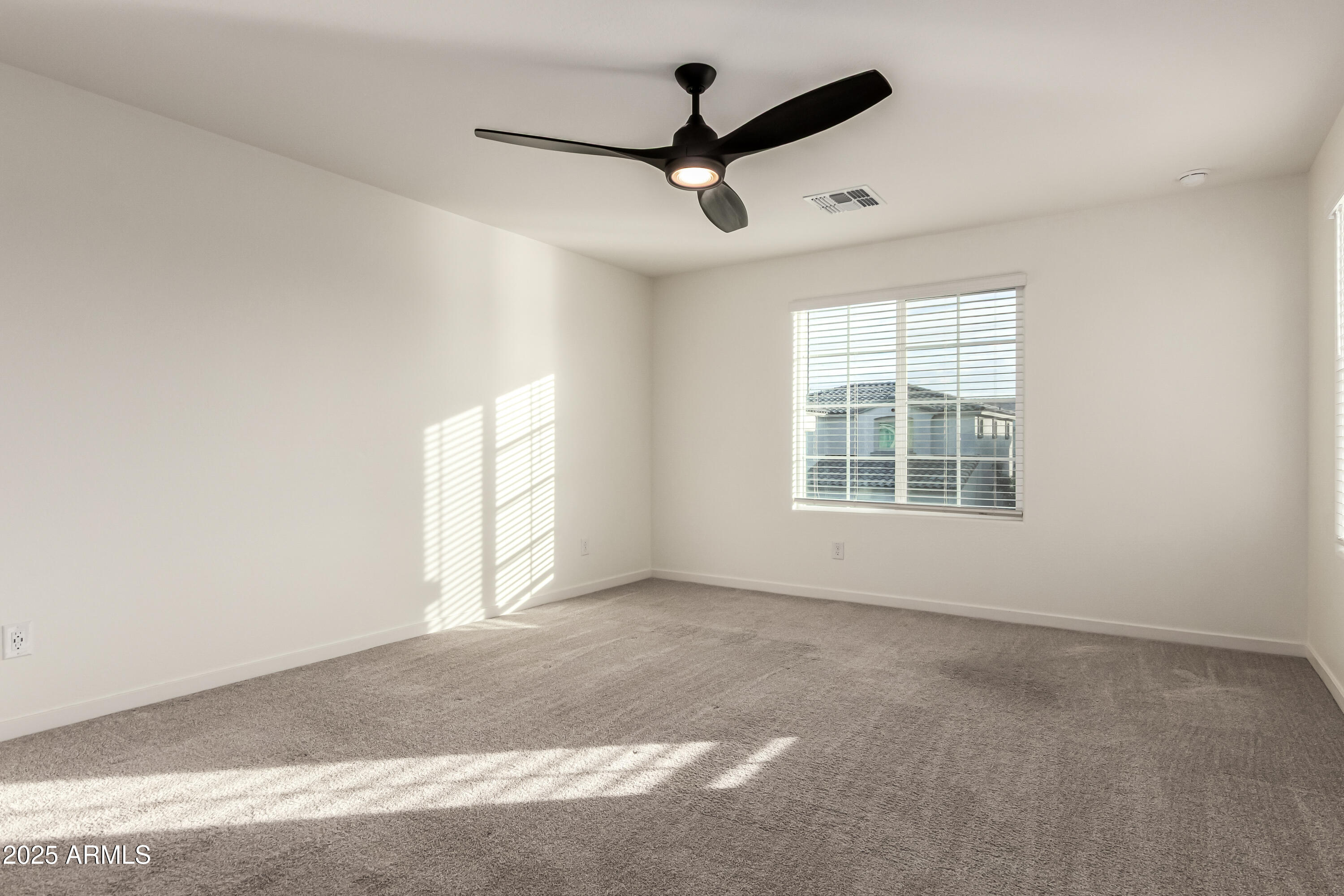 20 East Main Street Mesa, AZ 85201 - Photo 27 of 46 an empty room with windows and ceiling fan