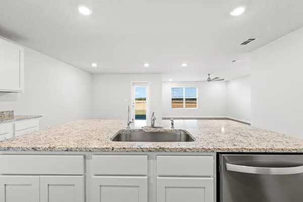a bathroom with a granite countertop sink and a granite