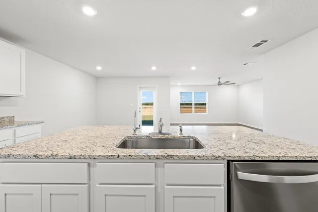 a bathroom with a granite countertop sink and a granite