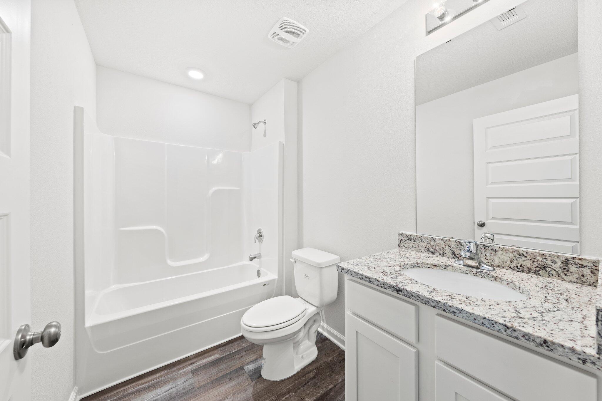 733 Quintana Street Crestview, FL 32539 - Photo 19 of 25 a bathroom with a granite countertop sink toilet and shower