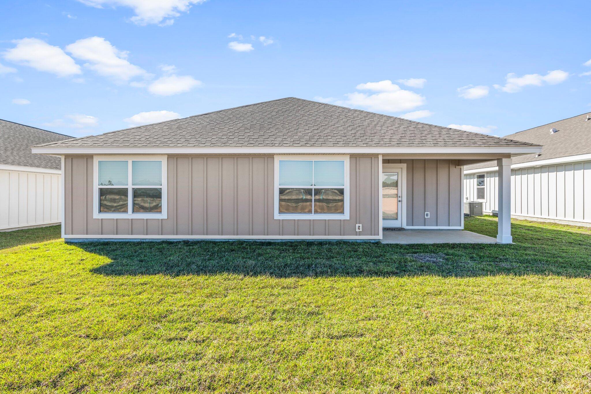 733 Quintana Street Crestview, FL 32539 - Photo 23 of 25 a front view of a house with garden