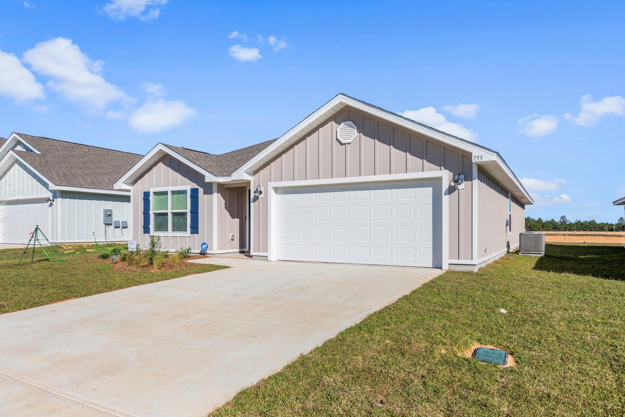 733 Quintana Street Crestview, FL 32539 - Photo 4 of 25 a front view of a house with a yard and garage
