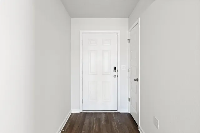 a view of front door with wooden floor