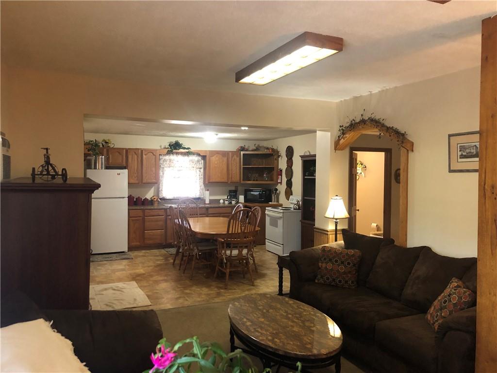 629 River Road Confluence, PA 15424 - Photo 14 of 50 a living room with furniture a fireplace and a kitchen view