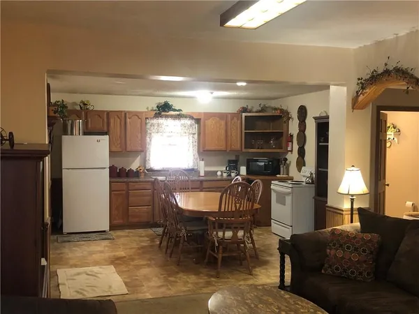 a living room with furniture a window and kitchen view