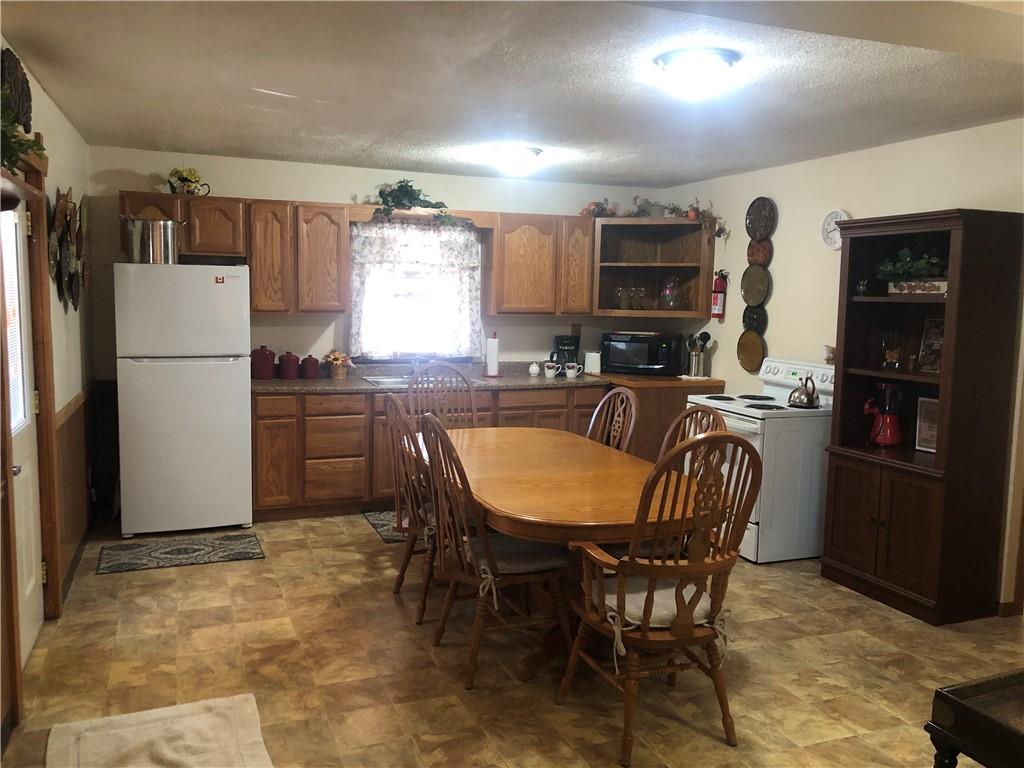 629 River Road Confluence, PA 15424 - Photo 17 of 50 a kitchen with stainless steel appliances granite countertop a dining table chairs refrigerator and sink