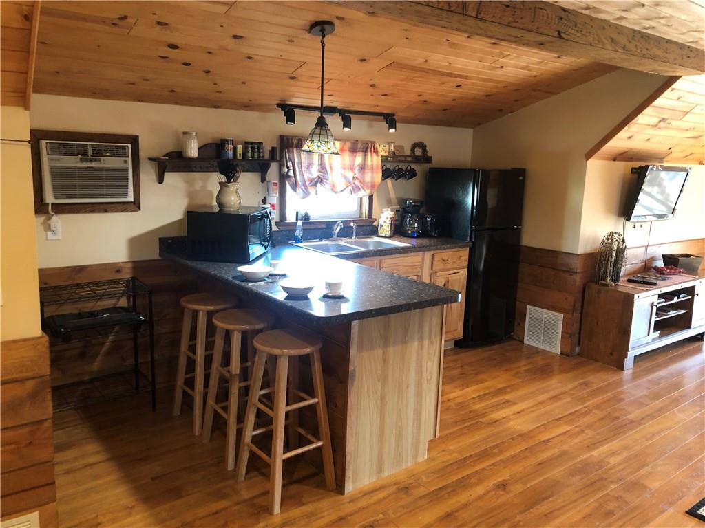 629 River Road Confluence, PA 15424 - Photo 30 of 50 a kitchen with stainless steel appliances kitchen island granite countertop a table chairs and a refrigerator