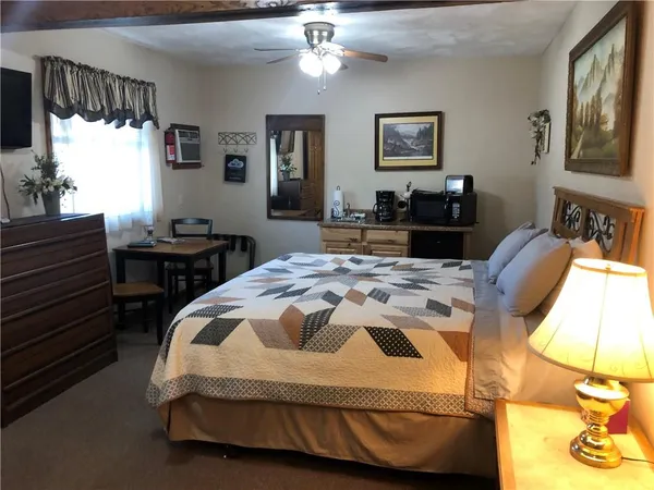 a large bed sitting in a bedroom next to a bedroom with furniture