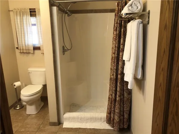 a bathroom with a granite countertop toilet and a sink