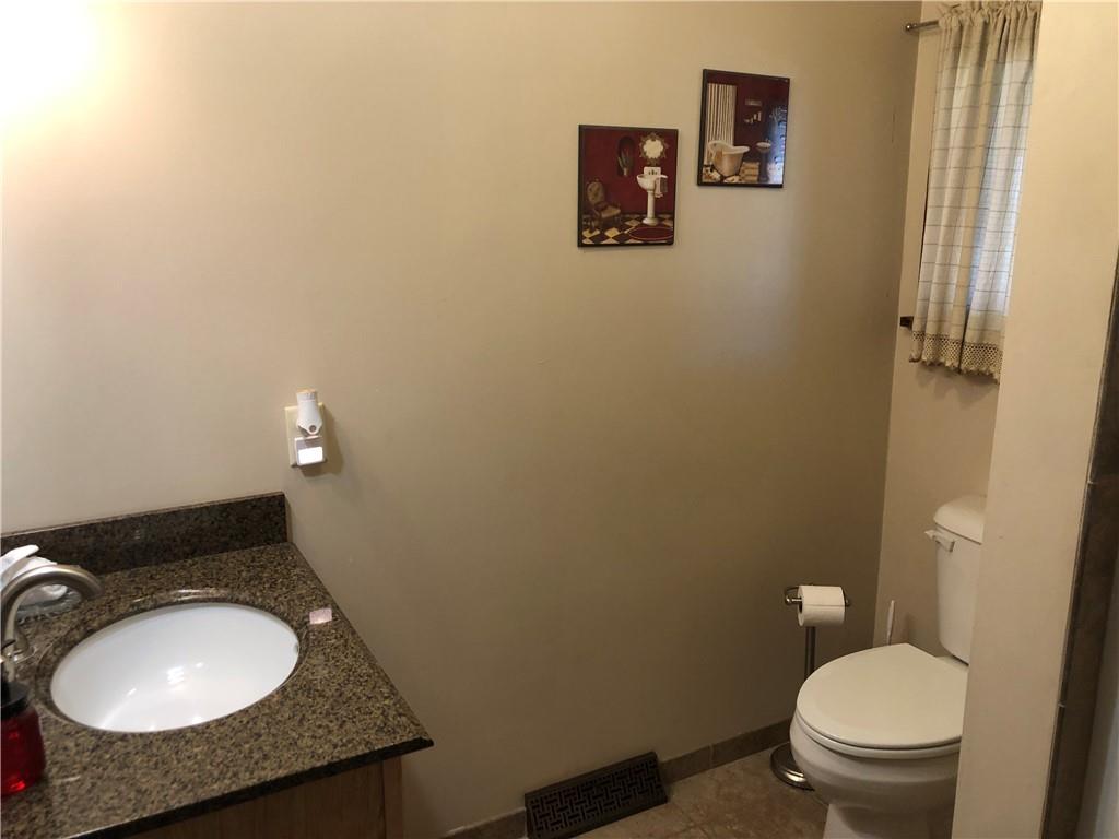 629 River Road Confluence, PA 15424 - Photo 44 of 50 a bathroom with a granite countertop toilet and a sink