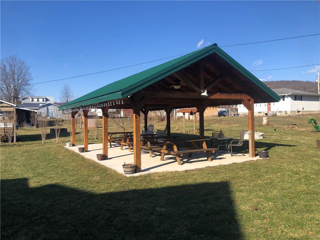 629 River Road Confluence, PA 15424 - Photo 7 of 50 a view of a patio with table and chairs under an umbrella