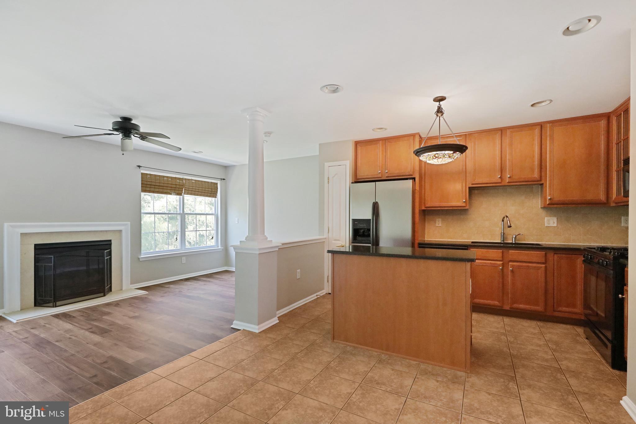 1041 Buckingham Thorofare, NJ 08086 - Photo 14 of 35 a kitchen with granite countertop a stove a sink and a refrigerator