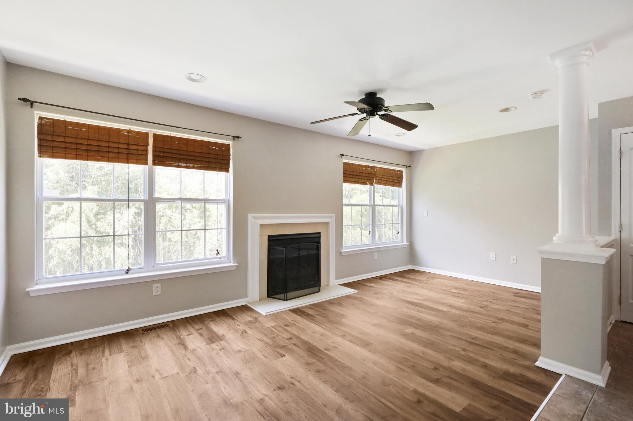 1041 Buckingham Thorofare, NJ 08086 - Photo 16 of 35 a view of an empty room with a fireplace and a window
