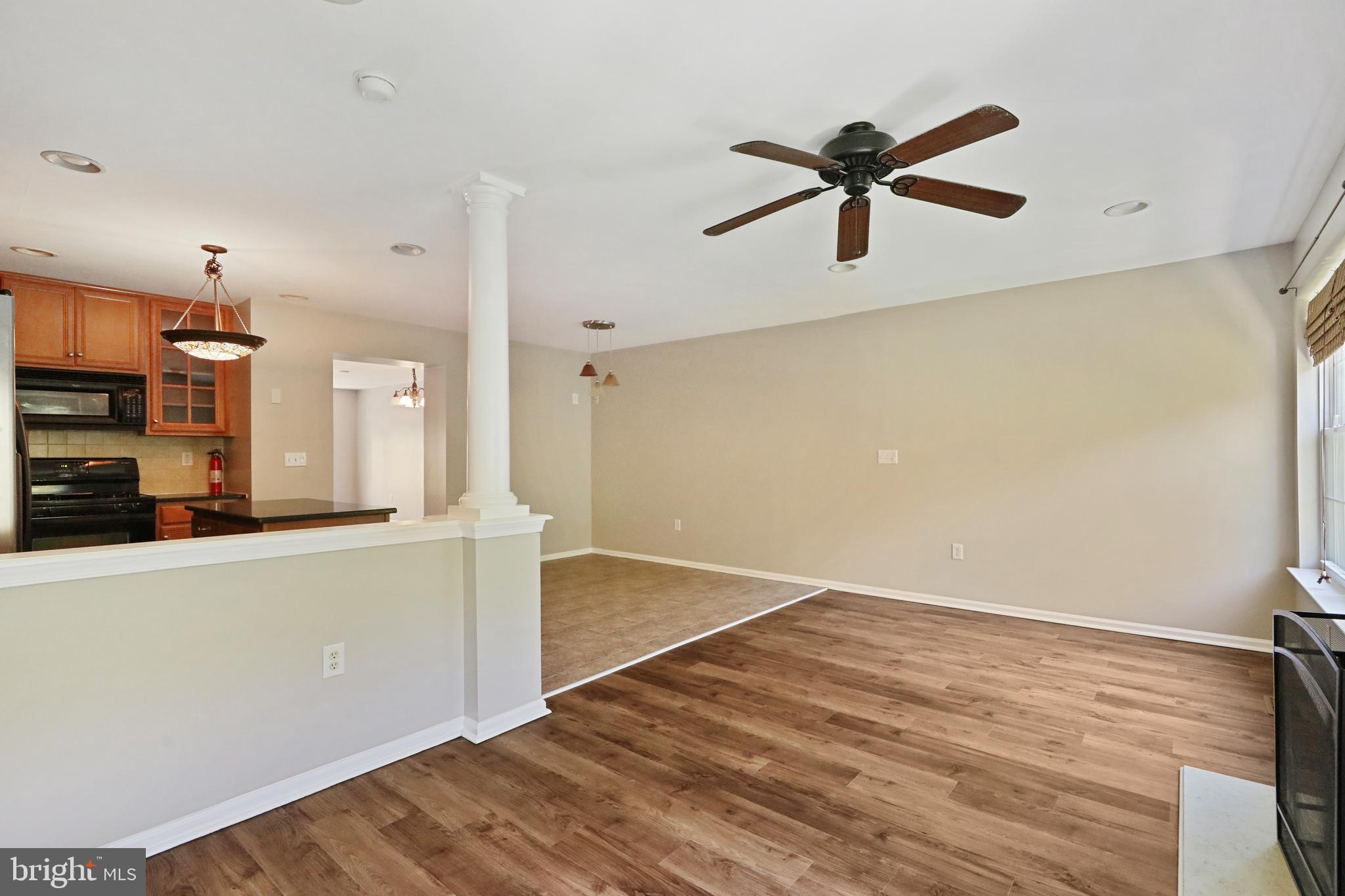 1041 Buckingham Thorofare, NJ 08086 - Photo 17 of 35 a view of a kitchen with wooden floor and a ceiling fan