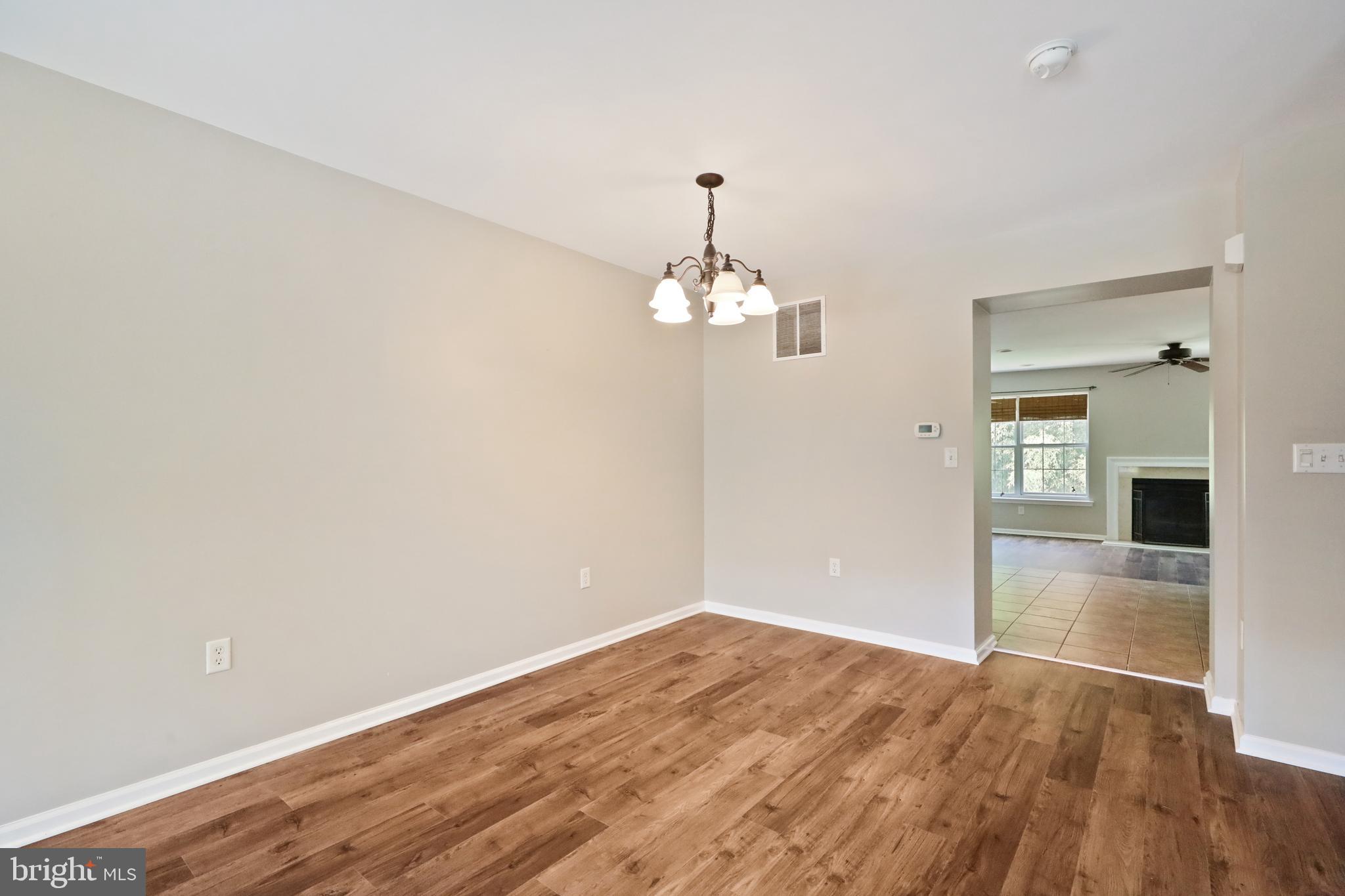 1041 Buckingham Thorofare, NJ 08086 - Photo 19 of 35 wooden floor in an empty room with a window