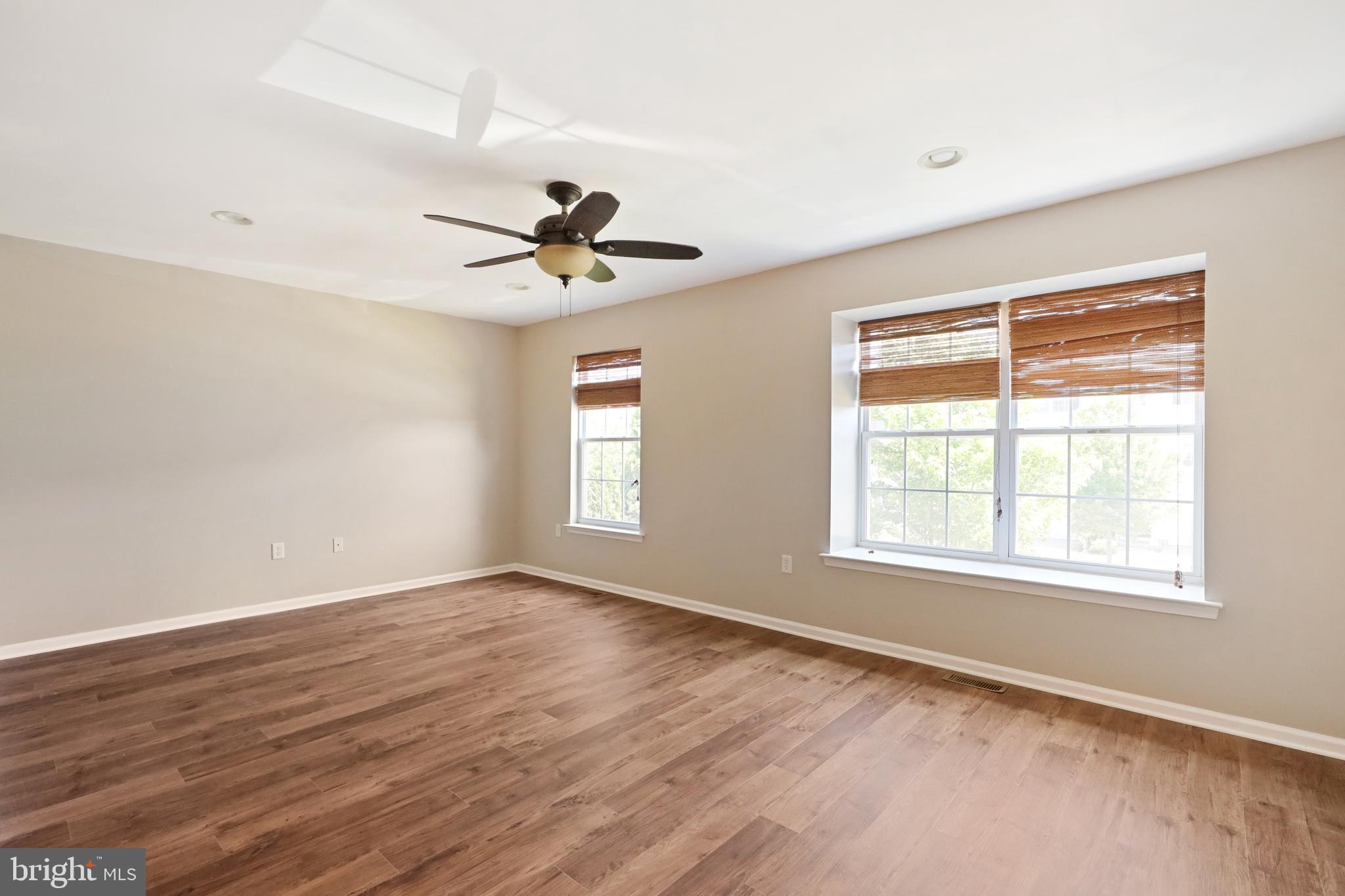 1041 Buckingham Thorofare, NJ 08086 - Photo 21 of 35 an empty room with wooden floor and windows