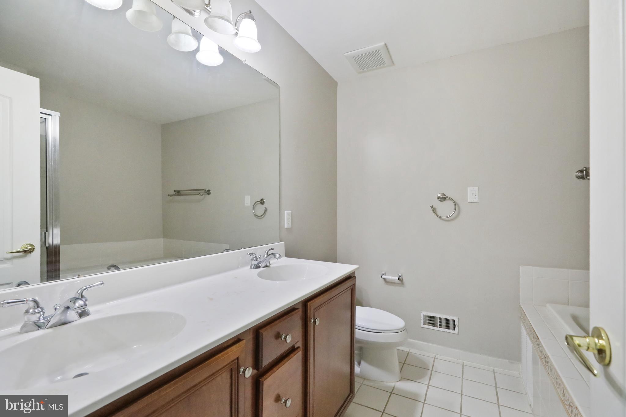 1041 Buckingham Thorofare, NJ 08086 - Photo 26 of 35 a view of bathroom with a sink mirror and toilet