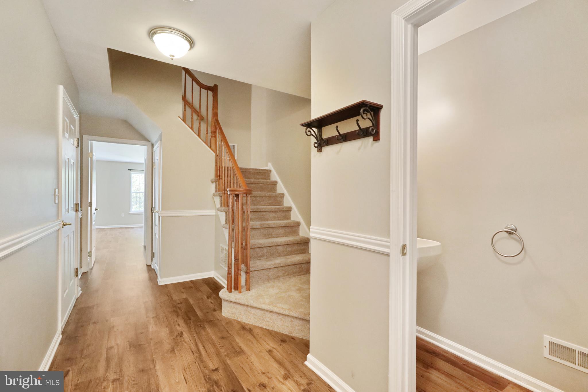 1041 Buckingham Thorofare, NJ 08086 - Photo 5 of 35 a view of a hallway with wooden floor and staircase