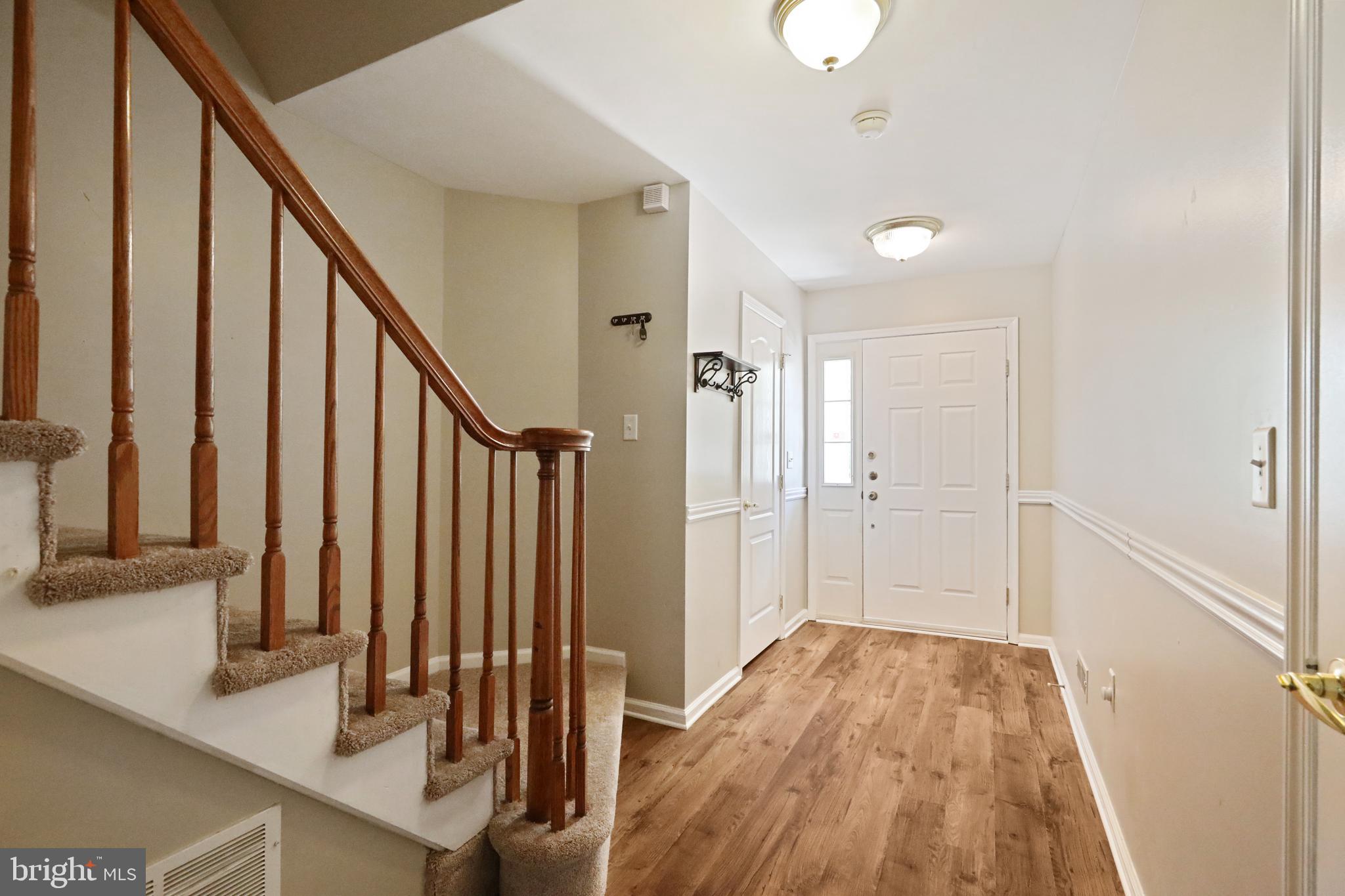 1041 Buckingham Thorofare, NJ 08086 - Photo 6 of 35 a view of a hallway with wooden floor and staircase