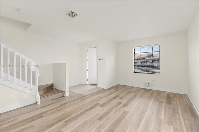 a kitchen with stainless steel appliances granite countertop a sink stove microwave and refrigerator