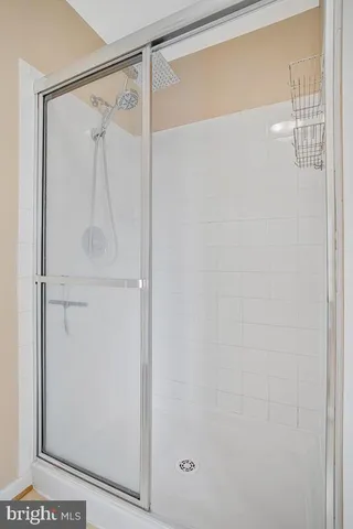 a bathroom with a glass shower door
