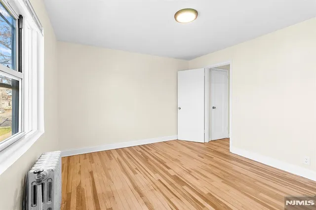 a view of a room with wooden floor and white walls