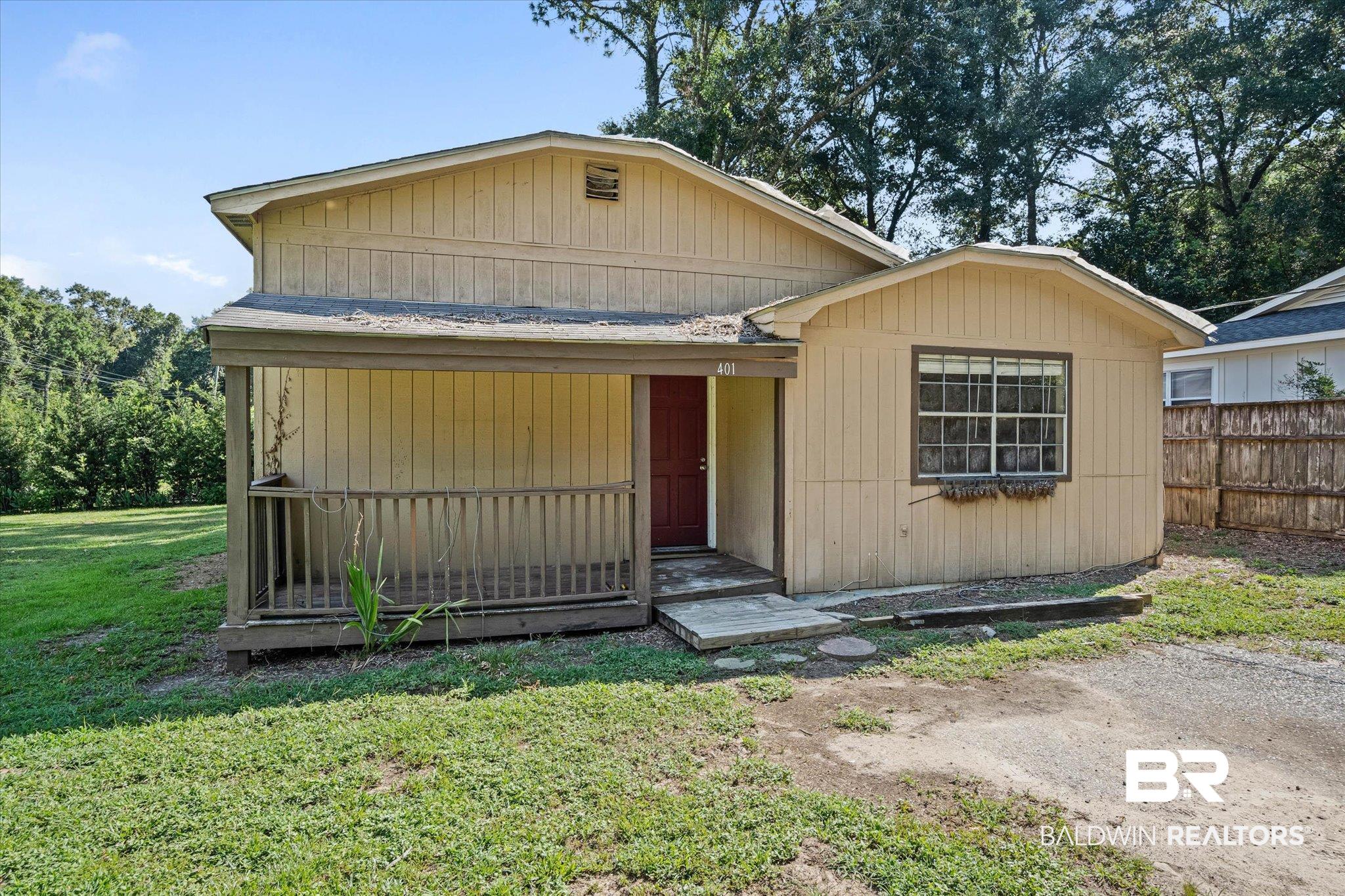 401 Frederick Avenue Fairhope, AL 36532 - Photo 32 of 36 Single-story residence featuring a covered front porch with wood railings and a red entry door