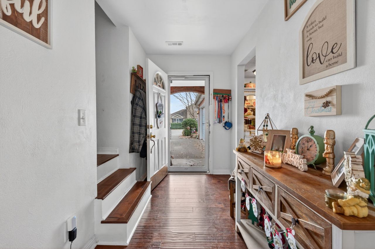 6045 Firelight Trail Antioch, TN 37013 - Photo 2 of 47 a hallway with a couch and a dining table next to a window