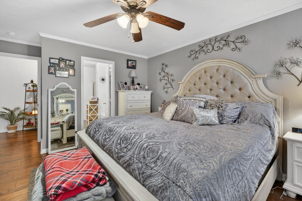 6045 Firelight Trail Antioch, TN 37013 - Photo 24 of 47 a bedroom with a large bed and a chandelier