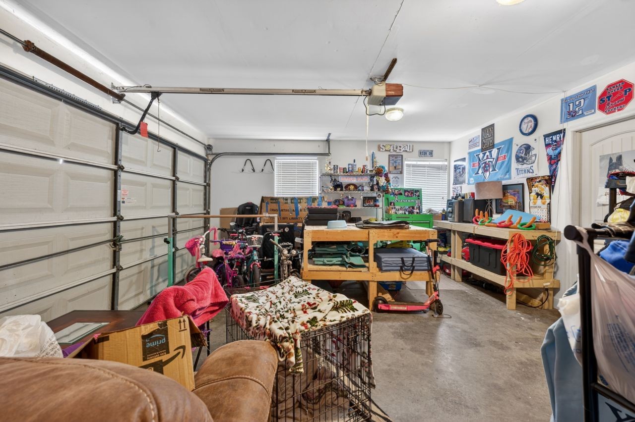 6045 Firelight Trail Antioch, TN 37013 - Photo 34 of 47 a living room with lots of furniture and a chandelier