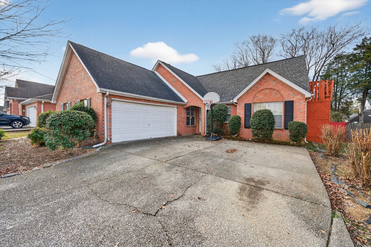 6045 Firelight Trail Antioch, TN 37013 - Photo 44 of 47 a backyard of a house with plants and large tree