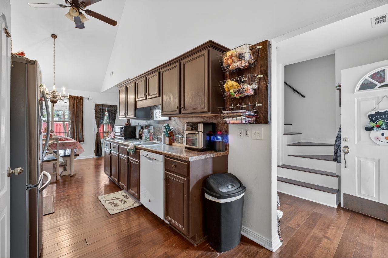 6045 Firelight Trail Antioch, TN 37013 - Photo 6 of 47 a kitchen with a refrigerator and wooden floor