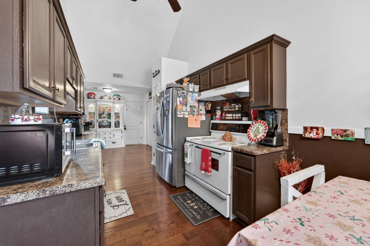 6045 Firelight Trail Antioch, TN 37013 - Photo 7 of 47 a storage room with stainless steel appliances kitchen island granite countertop a stove and a refrigerator