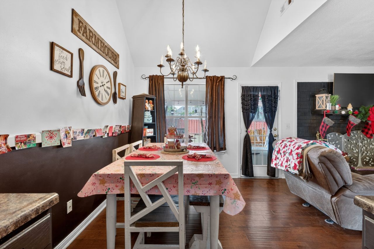 6045 Firelight Trail Antioch, TN 37013 - Photo 9 of 47 a view of a dining room with furniture a chandelier and wooden floor