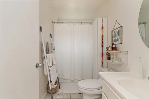 a bathroom with a sink a toilet and shower curtain