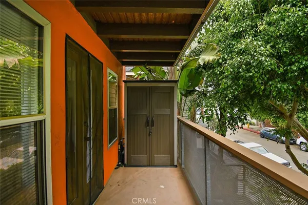 a view of a balcony with chairs and table
