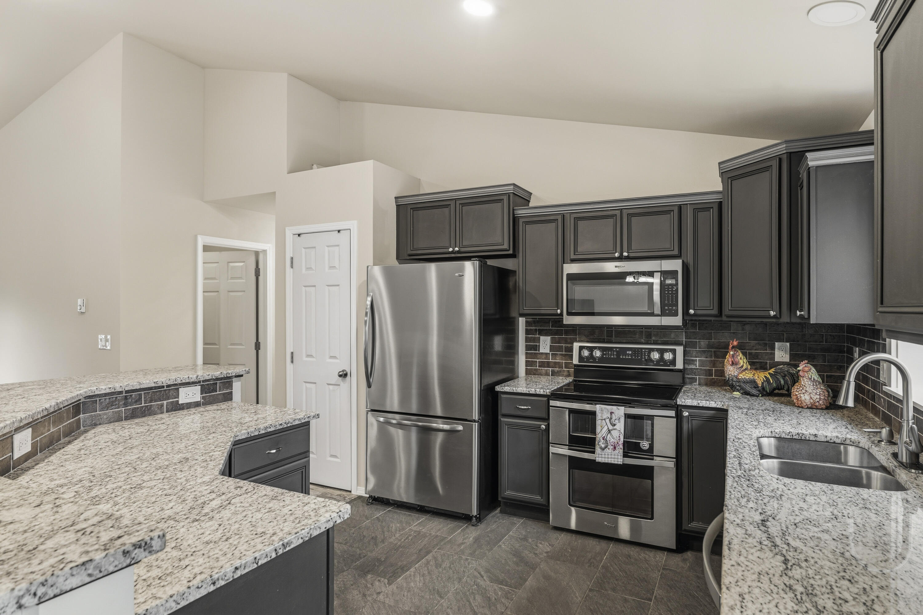 16050 Dick Road La Pine, OR 97739 - Photo 15 of 59 a kitchen with stainless steel appliances granite countertop a refrigerator stove and oven