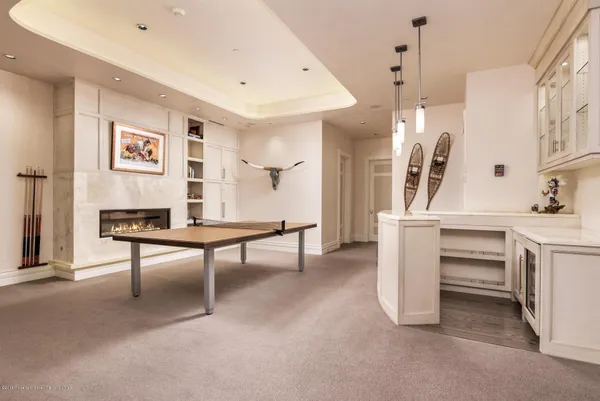 a living room with furniture a rug and white walls