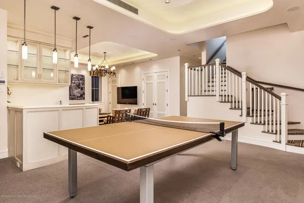 a room with pool table and a chandelier