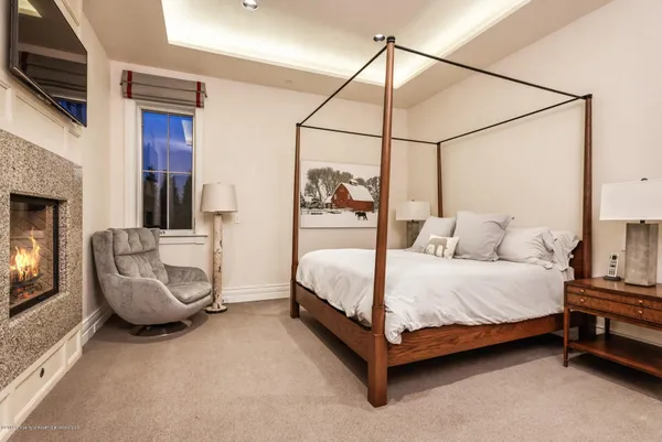 a bedroom with a bed a couch and dresser