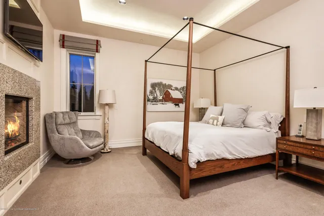 a bedroom with a bed a couch and dresser