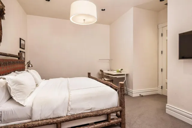 a bedroom with a bed and a tv