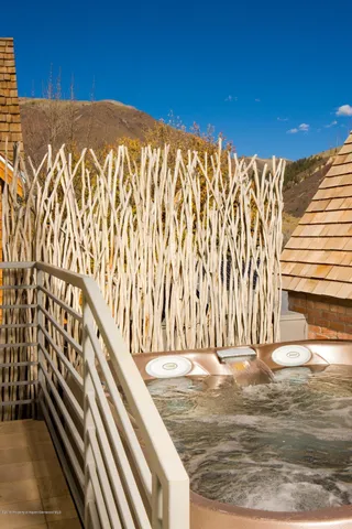 a view of a water fountain with wooden fence