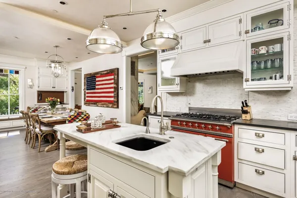 a kitchen with a stove a table and chairs in it