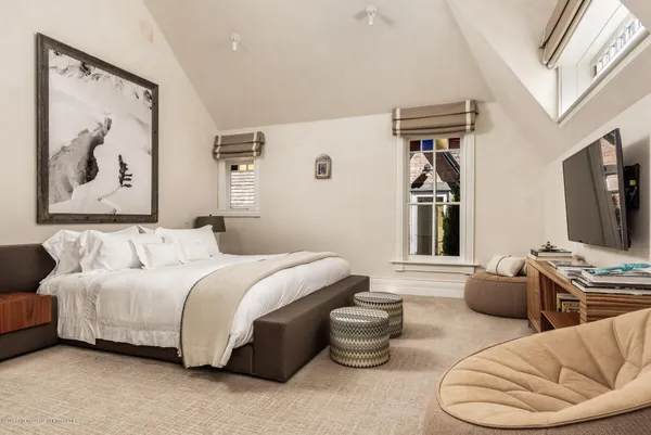 a spacious bedroom with a bed and a couch