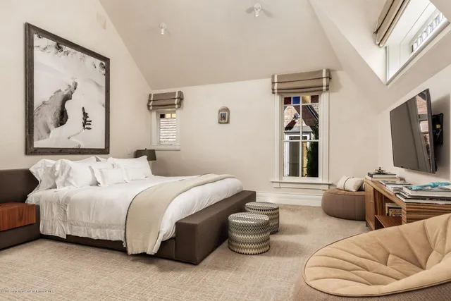 a spacious bedroom with a bed and a couch