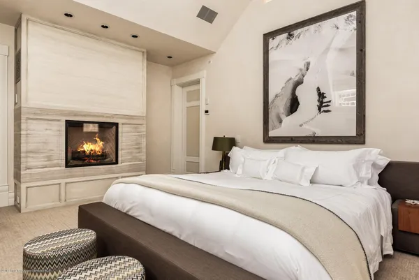 a bedroom with a bed and a painting on the wall