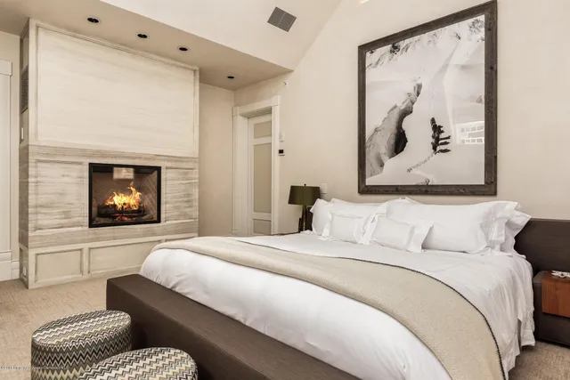 a bedroom with a bed and a painting on the wall