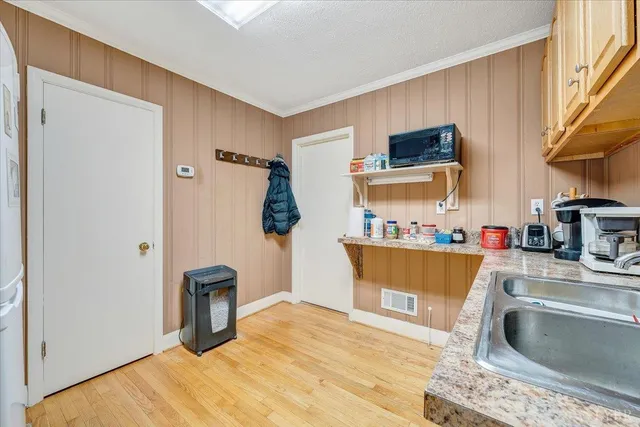 a kitchen with stainless steel appliances granite countertop a refrigerator sink and cabinets